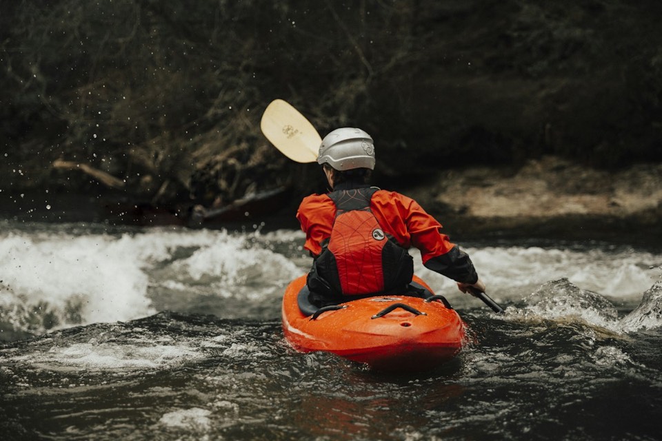 A kayaker paddling through whitewater